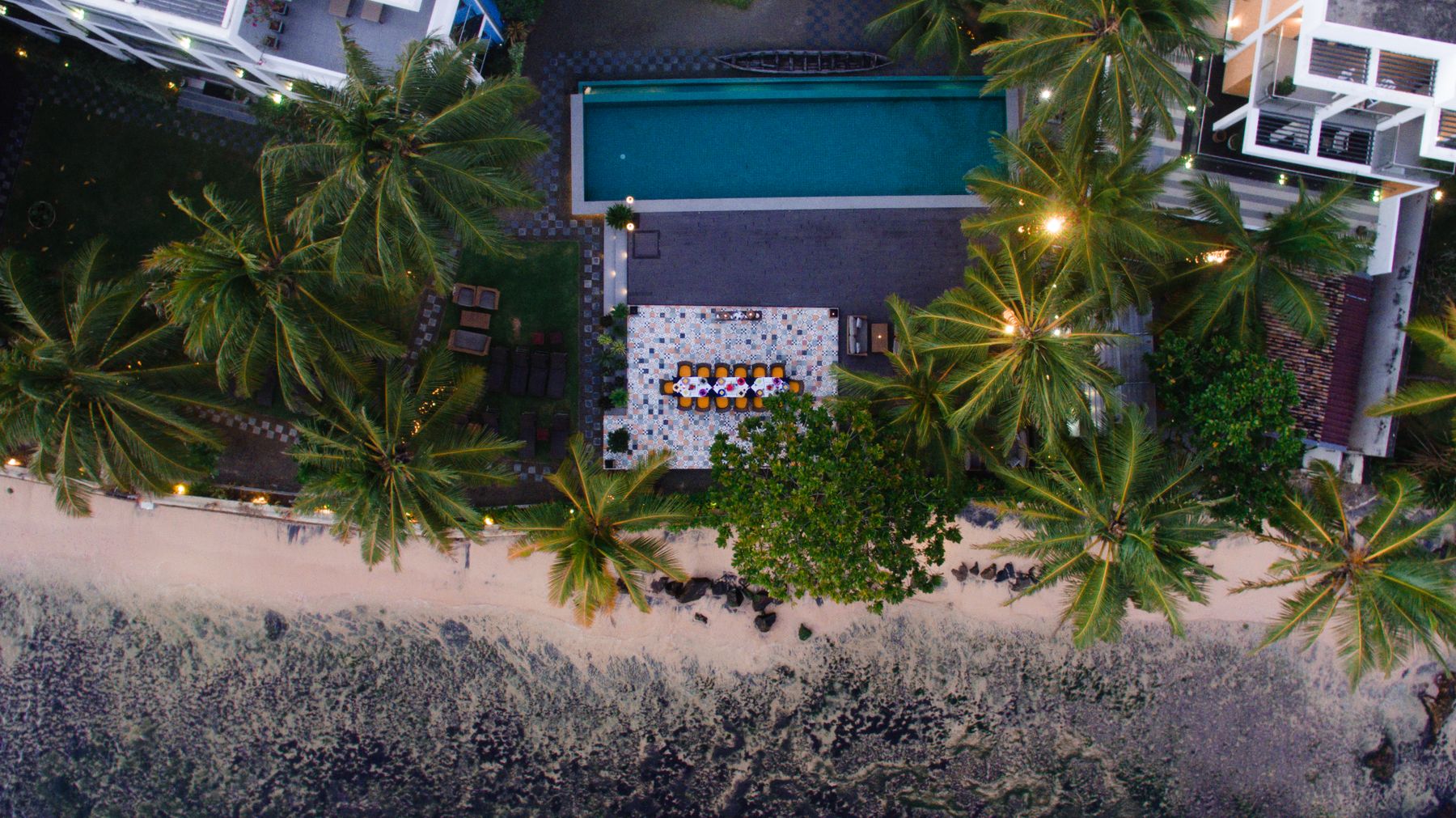 Vista aérea de piscina em resort à beira-mar.